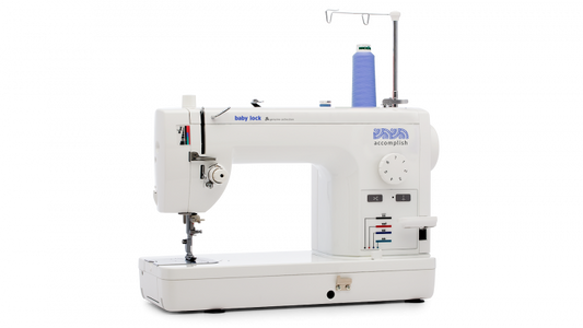 Baby Lock Accomplish sewing machine with blue thread spool on a white background