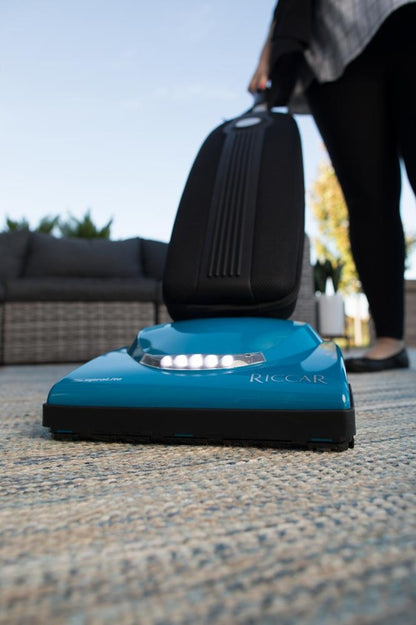 Riccar Cordless SupraLite R10CV.10 LED headlight cleaning an area rug